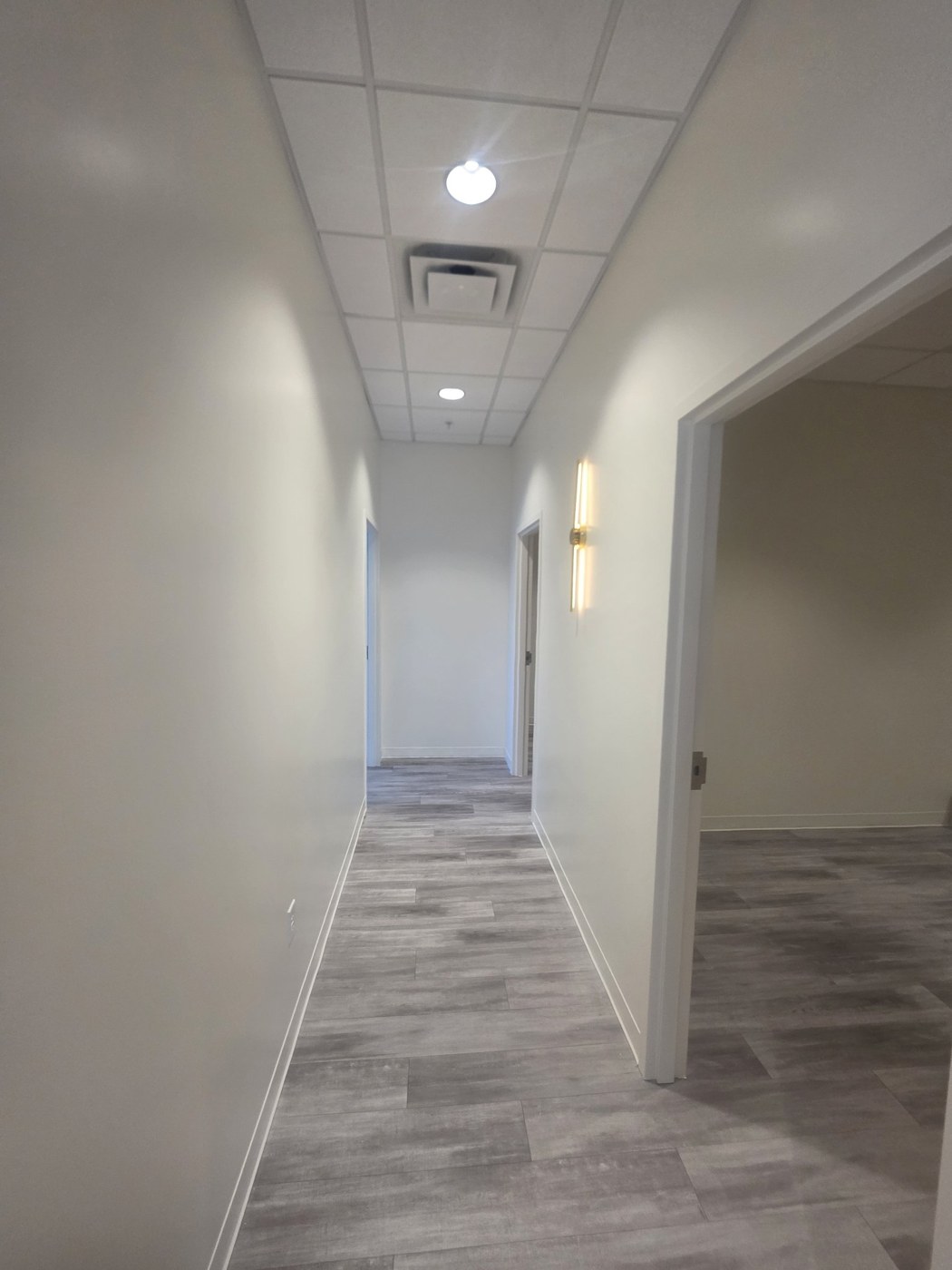 Same hallway repainted bright white, after