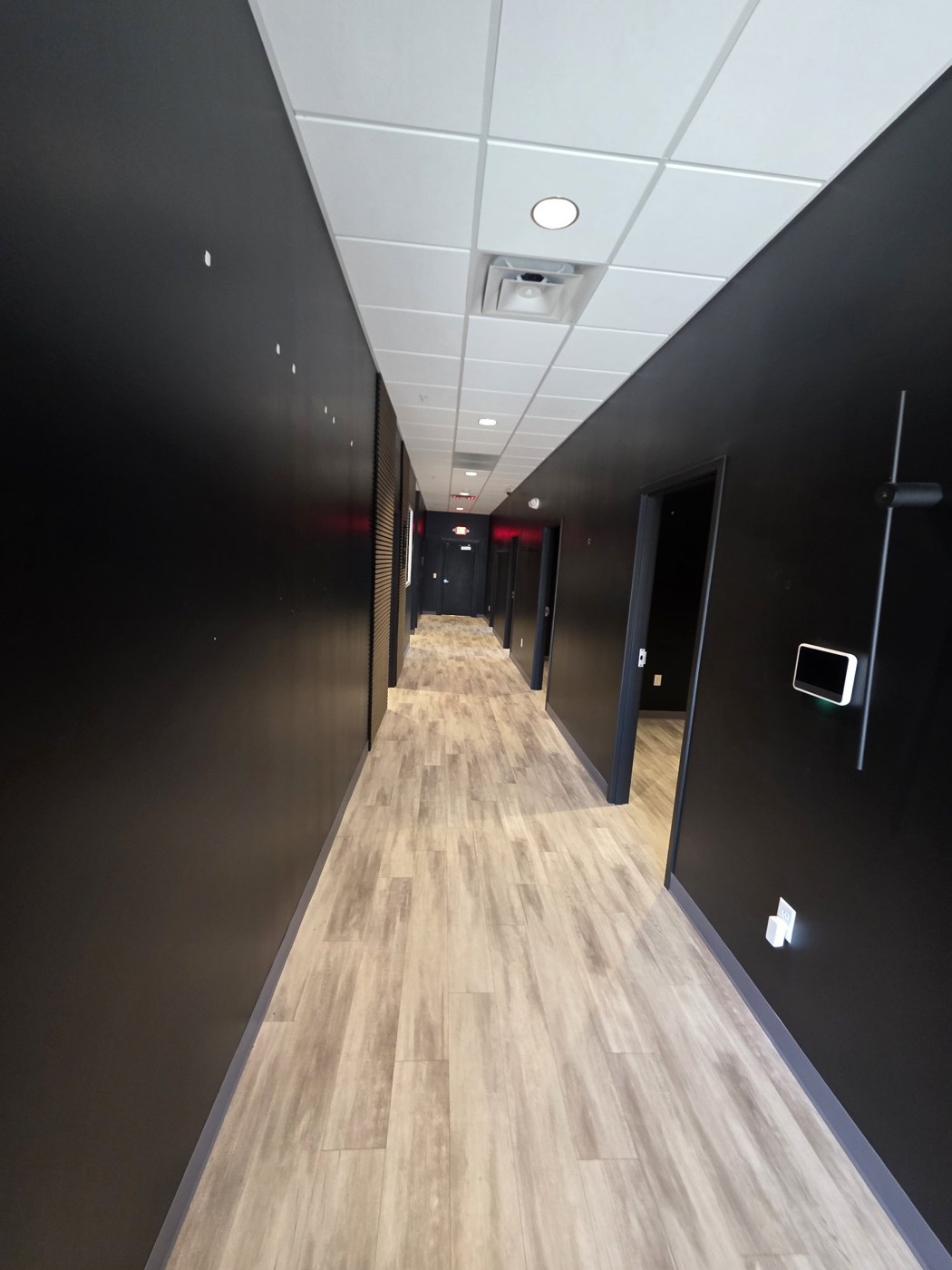 Commercial hallway painted black, before